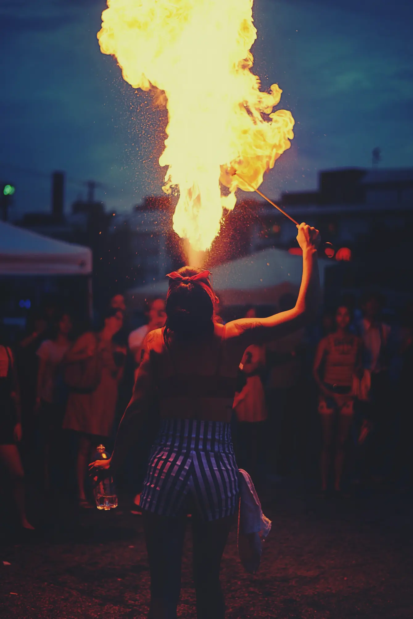 Picture of a person Blowing gas onto a torch