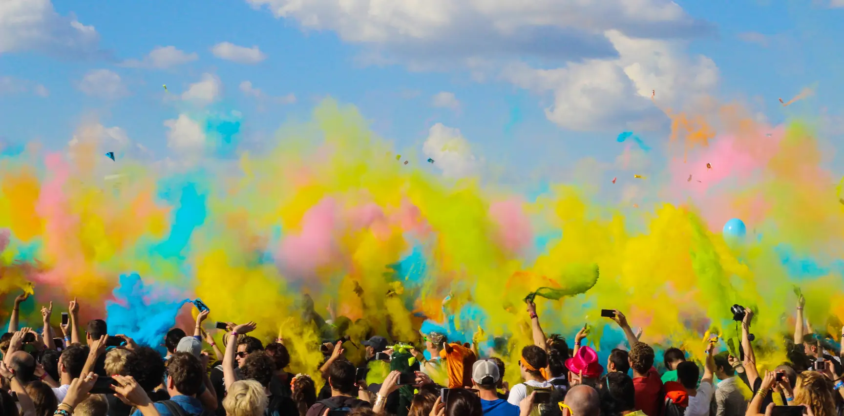 Picture of a group of people throwing colored smoke around